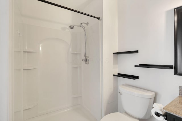 bathroom with vanity, toilet, and walk in shower