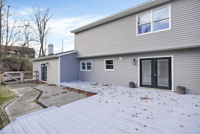 back of property with a wooden deck and french doors