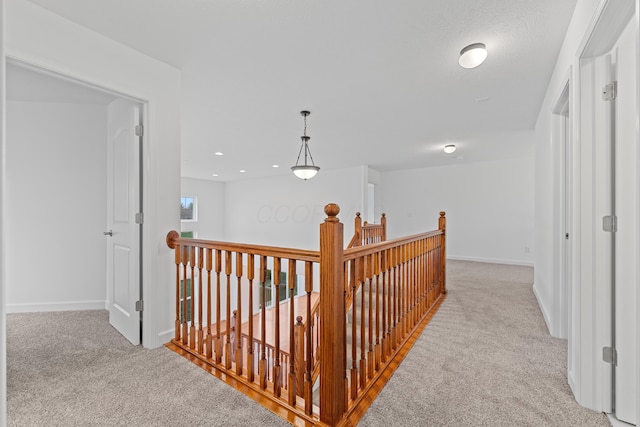 corridor featuring light colored carpet