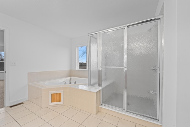 bathroom with tile patterned floors and independent shower and bath