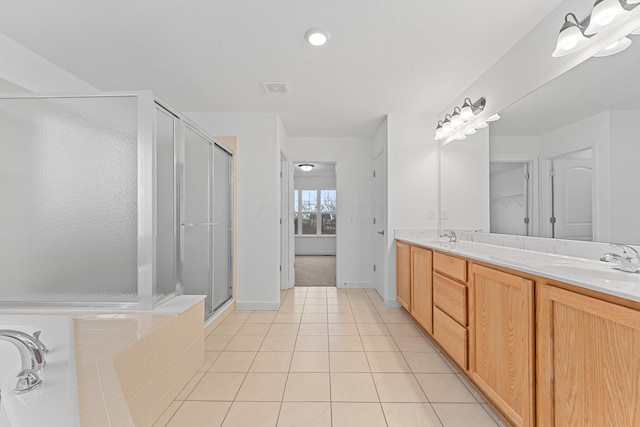 bathroom featuring tile patterned flooring, vanity, and an enclosed shower