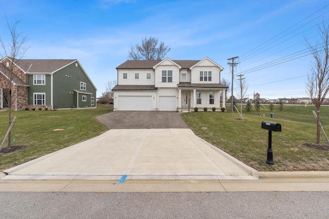 view of front of property featuring a front yard and a garage