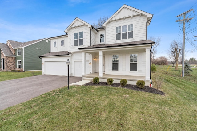 view of front of house featuring a porch, a garage, and a front lawn