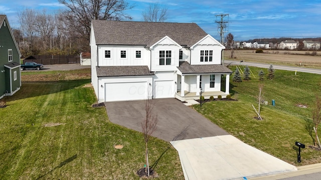 view of front of property with a garage and a front yard