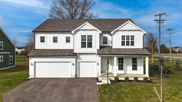 view of front of property with a front yard, a porch, and a garage