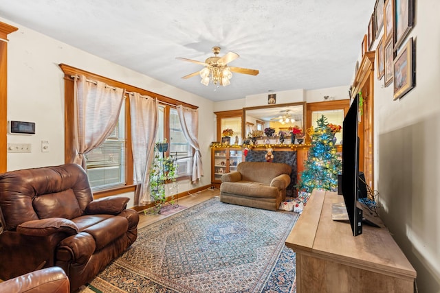 living room featuring ceiling fan and a textured ceiling