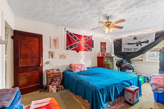 bedroom with carpet flooring, ceiling fan, and a textured ceiling