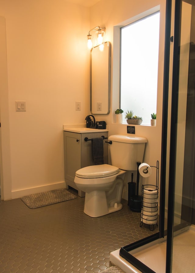 bathroom featuring tile patterned flooring, vanity, and toilet