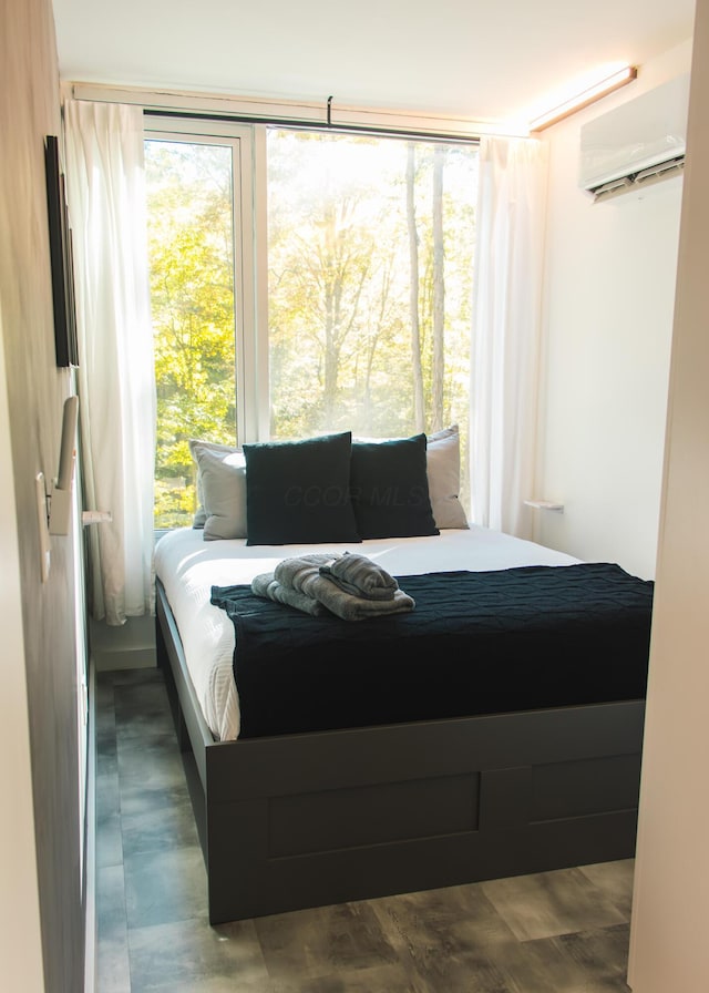 bedroom featuring a wall unit AC