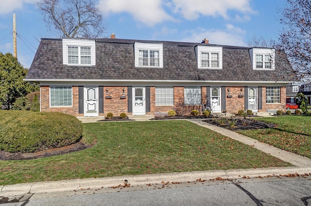 new england style home with a front lawn