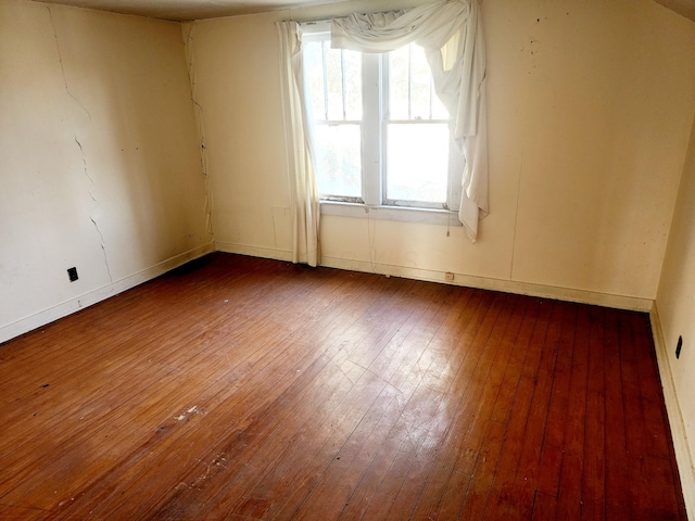 spare room with hardwood / wood-style floors