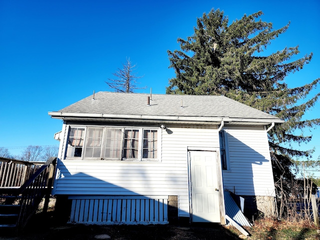 back of property with a wooden deck