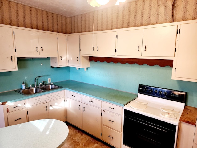 kitchen featuring electric stove, white cabinetry, sink, and tile patterned flooring