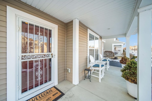 view of exterior entry with a porch