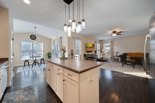 kitchen featuring pendant lighting, a wealth of natural light, dark hardwood / wood-style floors, and a kitchen island