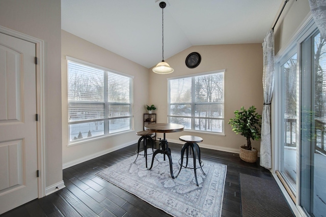 dining room with vaulted ceiling and dark hardwood / wood-style floors