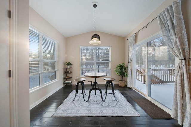 dining area featuring lofted ceiling