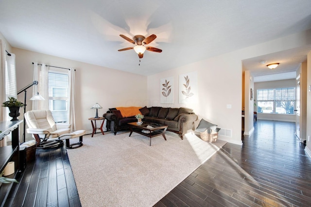 living room with ceiling fan and dark hardwood / wood-style floors