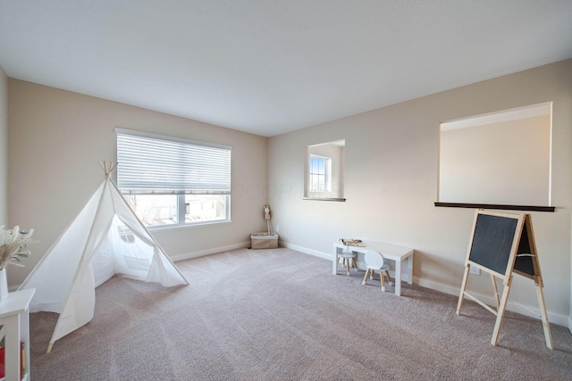 playroom featuring plenty of natural light and light carpet