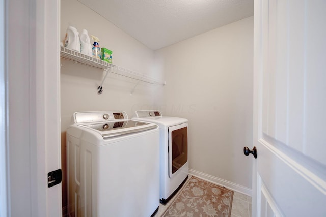 washroom with light tile patterned flooring and independent washer and dryer