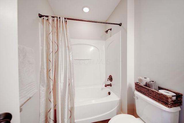 bathroom with toilet and shower / bath combo with shower curtain