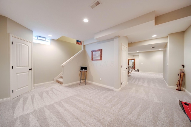 basement featuring light carpet