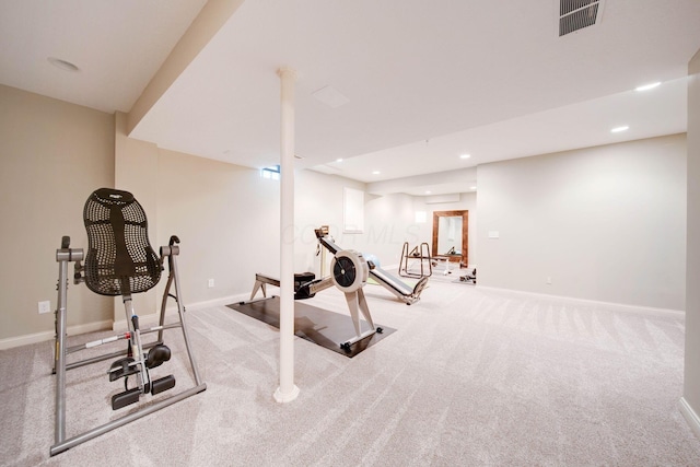 exercise room featuring light colored carpet