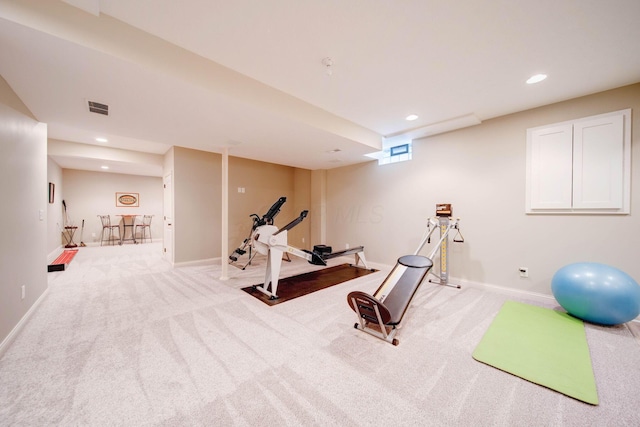 workout room featuring light colored carpet