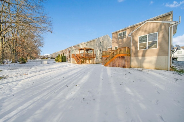 yard covered in snow with a wooden deck