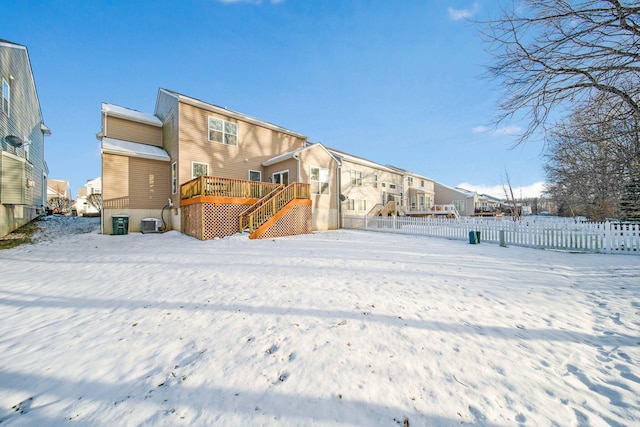 snow covered property featuring a deck