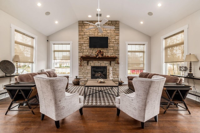 living room featuring ceiling fan, a stone fireplace, high vaulted ceiling, and dark hardwood / wood-style flooring