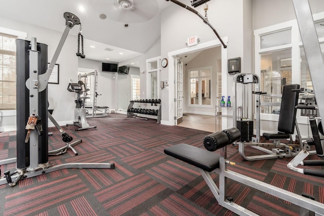 workout area featuring high vaulted ceiling