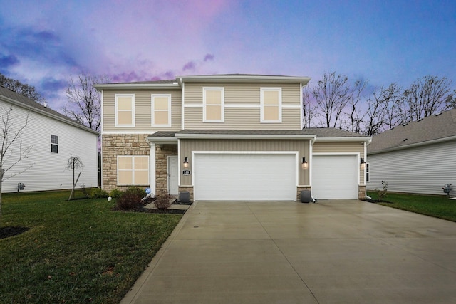 front facade featuring a garage and a yard