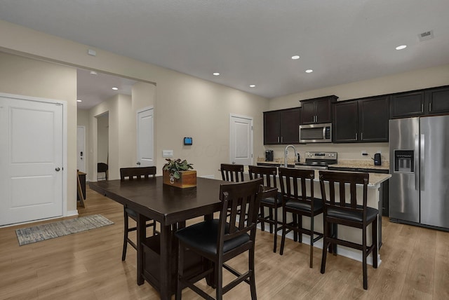 dining room featuring light hardwood / wood-style floors and sink