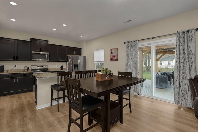 dining area with light hardwood / wood-style floors