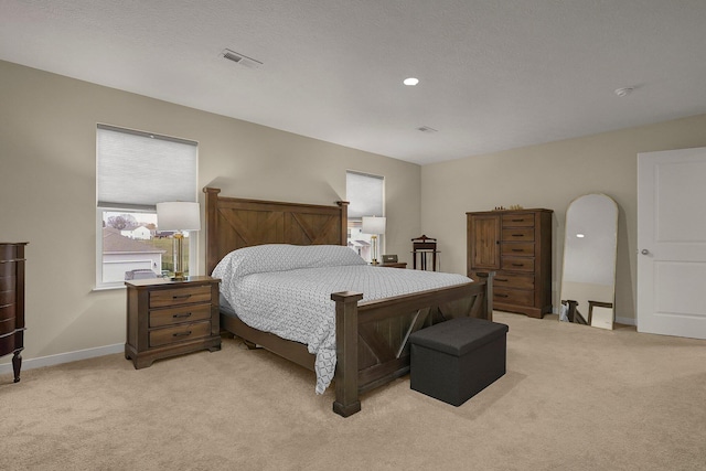 carpeted bedroom featuring a textured ceiling