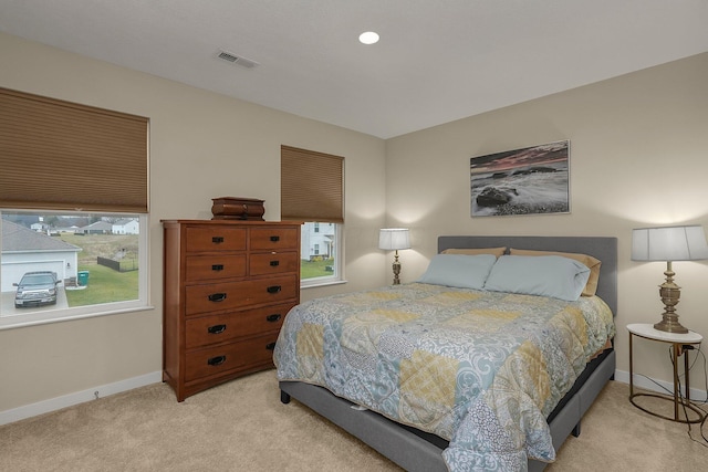 bedroom featuring light colored carpet