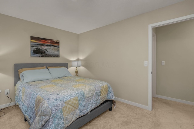 bedroom with light colored carpet