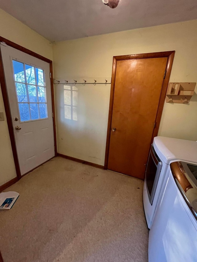 laundry room featuring washer and dryer and light colored carpet