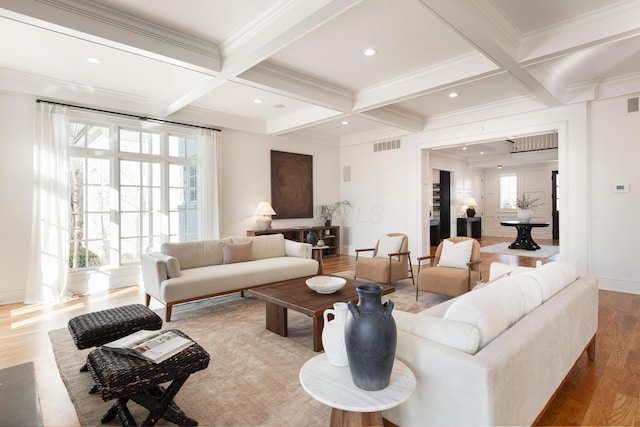 living room with coffered ceiling, light hardwood / wood-style floors, and beamed ceiling