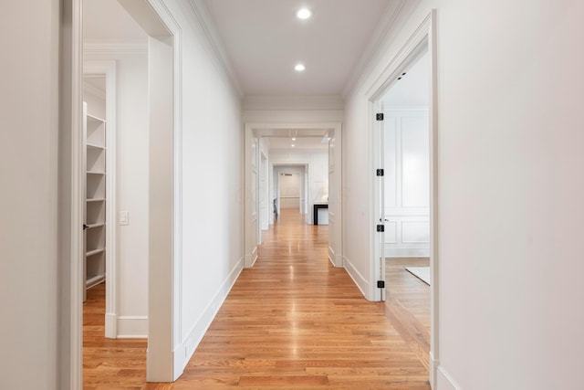 hall with crown molding and light wood-type flooring