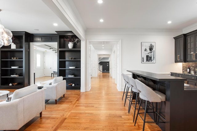 interior space with ornamental molding and light wood-type flooring