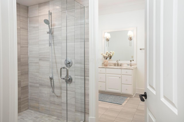 bathroom with vanity, tile patterned flooring, crown molding, and walk in shower