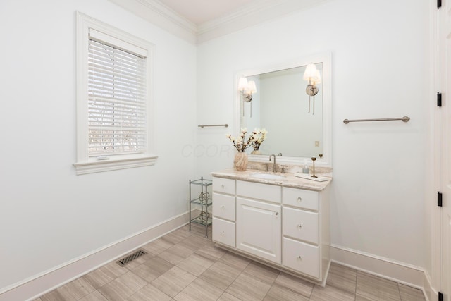 bathroom with ornamental molding and vanity