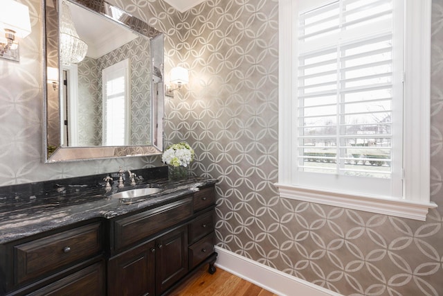 bathroom with vanity, hardwood / wood-style flooring, and a healthy amount of sunlight