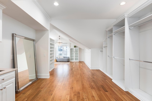 walk in closet featuring lofted ceiling and light hardwood / wood-style flooring