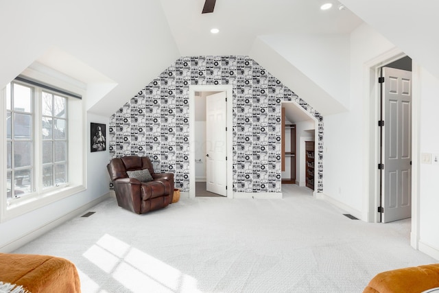 living area featuring vaulted ceiling and carpet floors