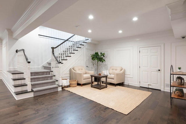 living room featuring crown molding and dark wood-type flooring