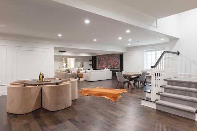 living room with crown molding and dark hardwood / wood-style floors