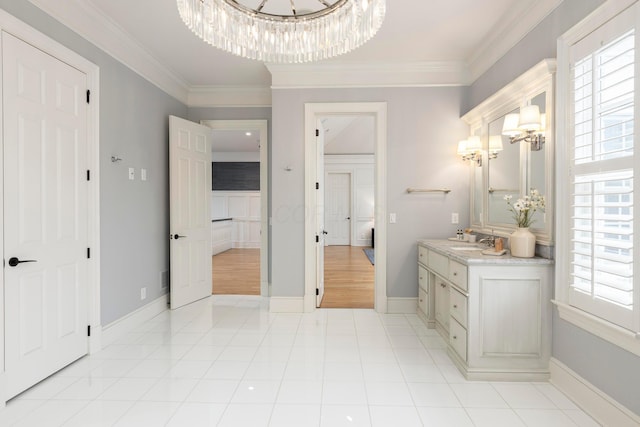 bathroom featuring tile patterned flooring, vanity, a notable chandelier, and crown molding